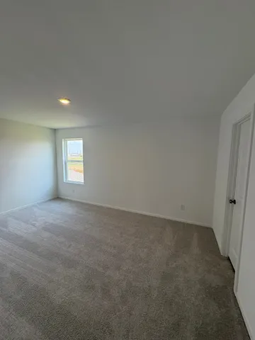 a view of an empty room and a window