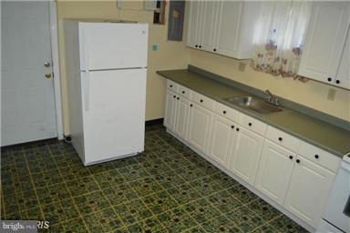 406 Irwin Street Silver Spring, MD 20901 - Photo 22 of 30 a kitchen with a refrigerator and a sink