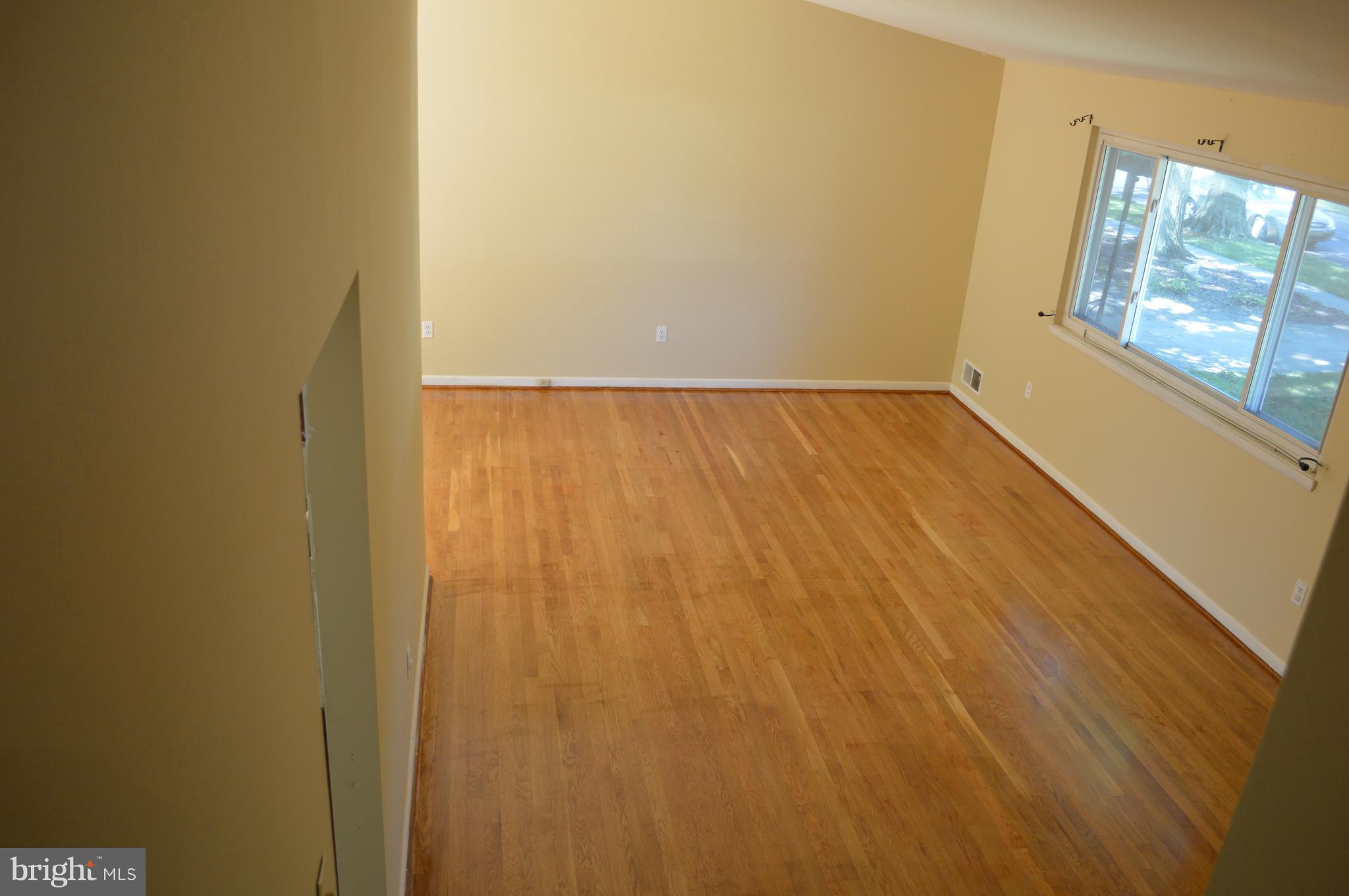 406 Irwin Street Silver Spring, MD 20901 - Photo 4 of 30 a view of room with window and wooden floor