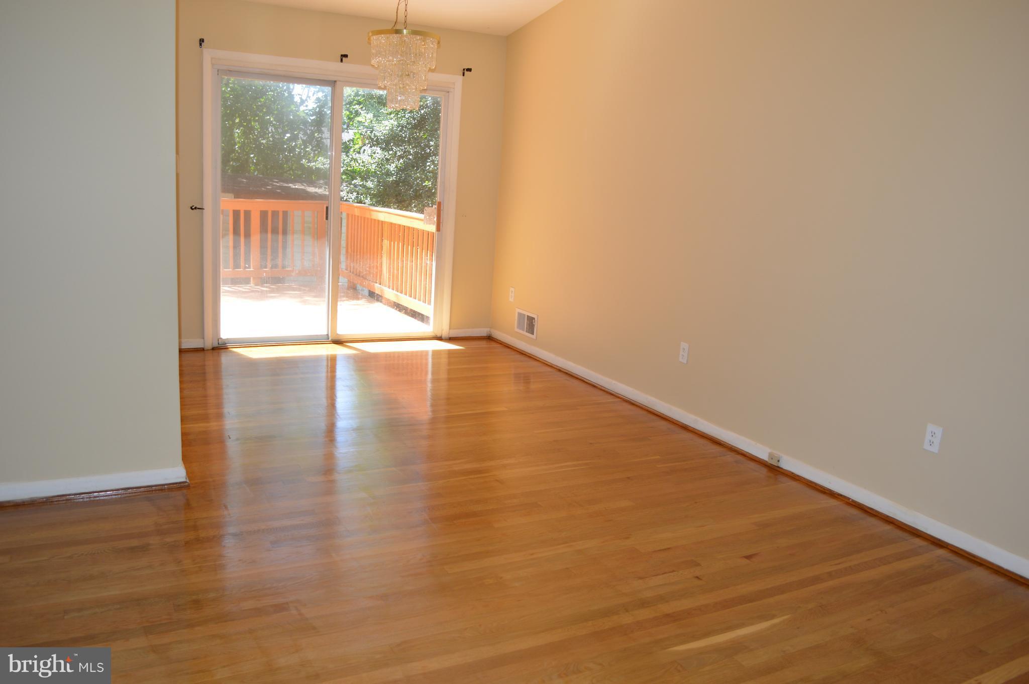 406 Irwin Street Silver Spring, MD 20901 - Photo 6 of 30 a view of an empty room with wooden floor and a window