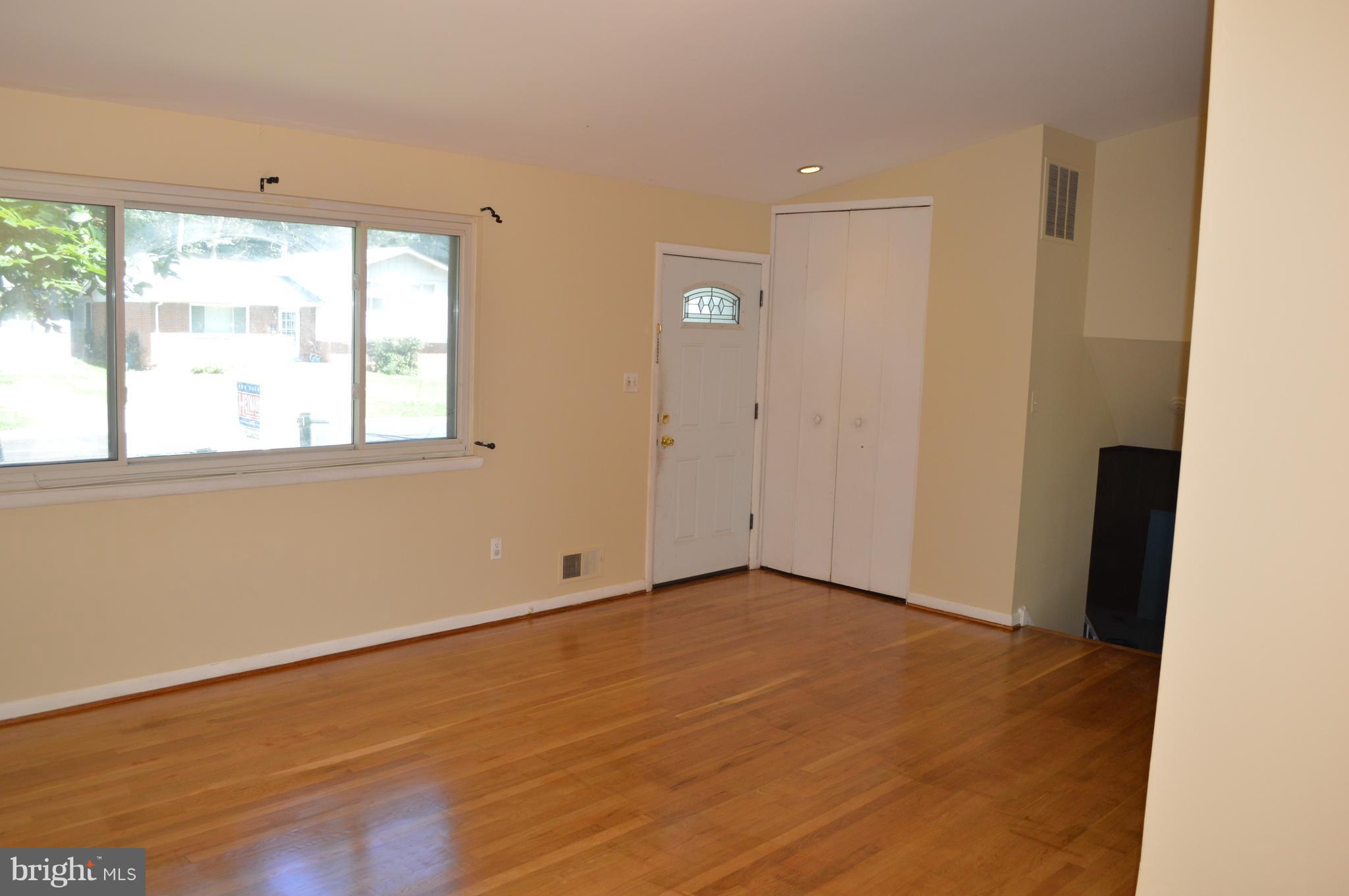 406 Irwin Street Silver Spring, MD 20901 - Photo 8 of 30 an empty room with wooden floor and windows