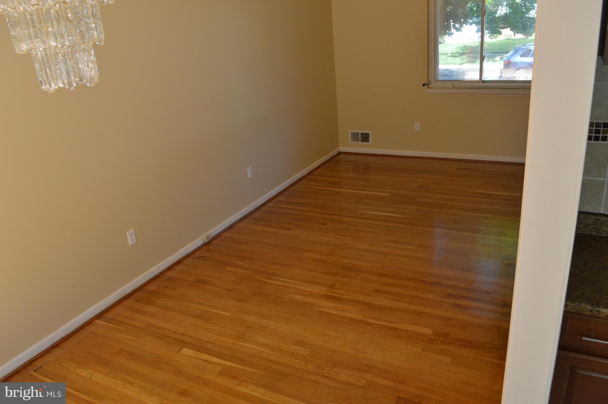 406 Irwin Street Silver Spring, MD 20901 - Photo 9 of 30 wooden floor in an empty room with a window