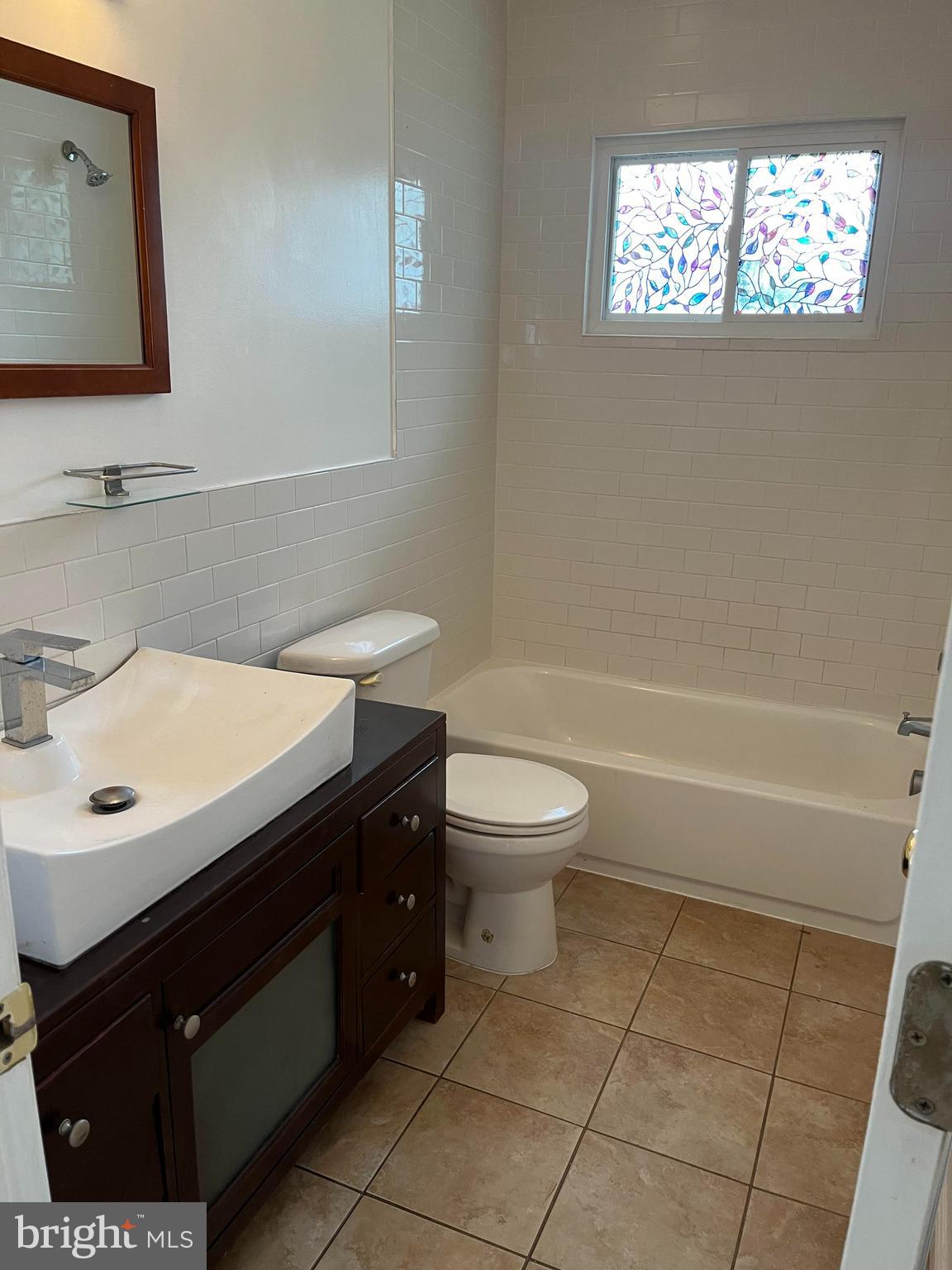4105 Isbell Street Silver Spring, MD 20906 - Photo 13 of 19 a bathroom with a sink toilet and mirror