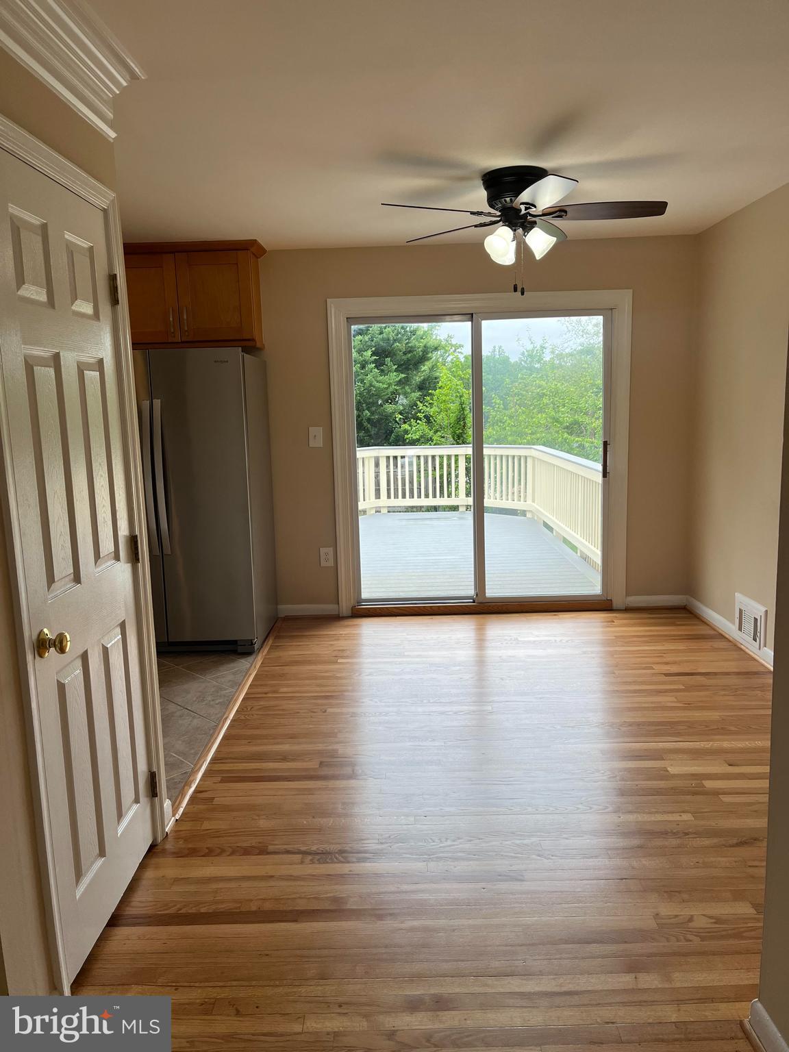 4105 Isbell Street Silver Spring, MD 20906 - Photo 9 of 19 a view of a livingroom with wooden floor a ceiling fan and windows