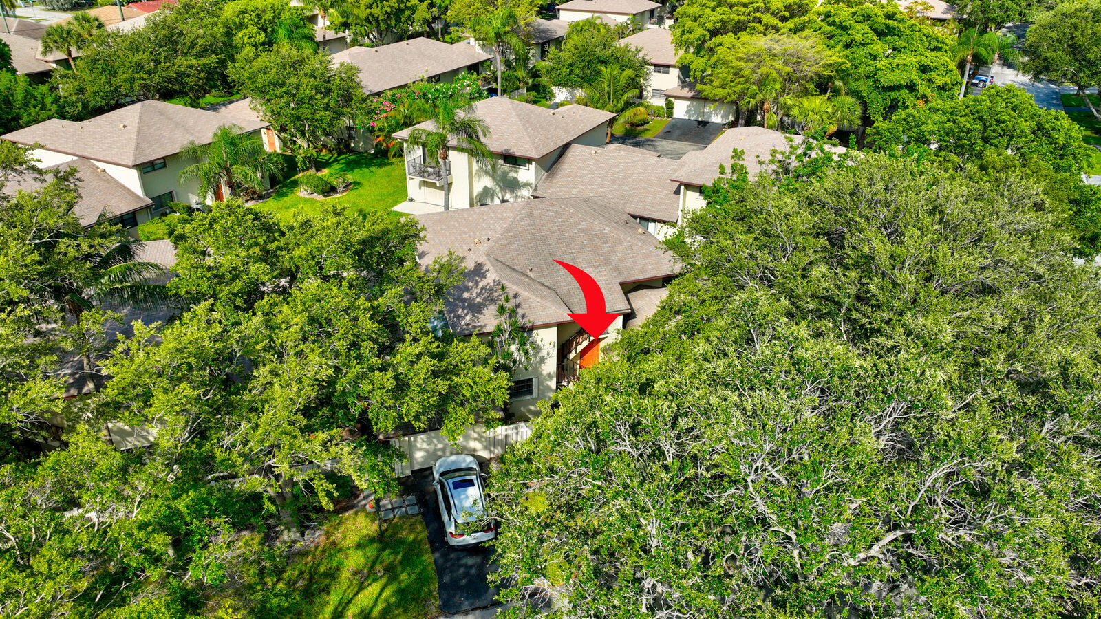 an aerial view of a house with a yard and lake view
