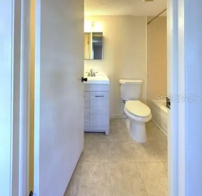 a bathroom with a toilet sink and a mirror