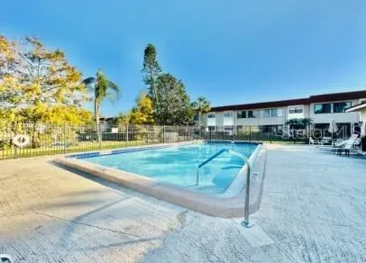 a swimming pool with outdoor seating and yard