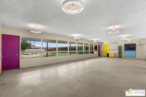 a view of an empty room with a floor to ceiling window and a room