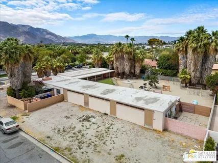 an aerial view of a house a garden and mountain view