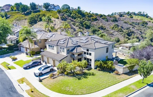 an aerial view of a house with a garden and lake view
