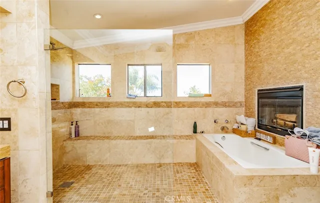 a bathroom with a tub sink and mirror