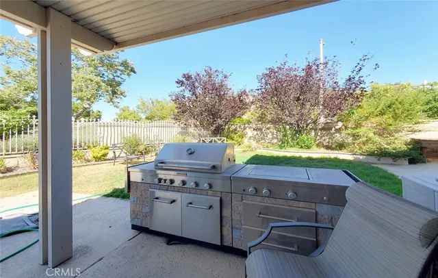 a view of a porch with furniture and a yard