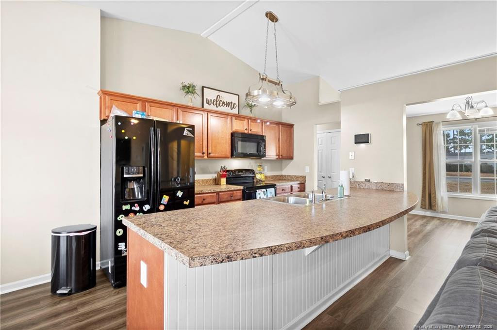 46 Old English Lane Spring Lake, NC 28390 - Photo 16 of 36 a kitchen with granite countertop a sink a counter top space cabinets stainless steel appliances and a chandelier