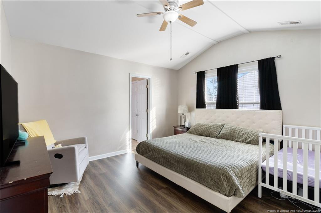 46 Old English Lane Spring Lake, NC 28390 - Photo 21 of 36 a bedroom with a bed and a chandelier