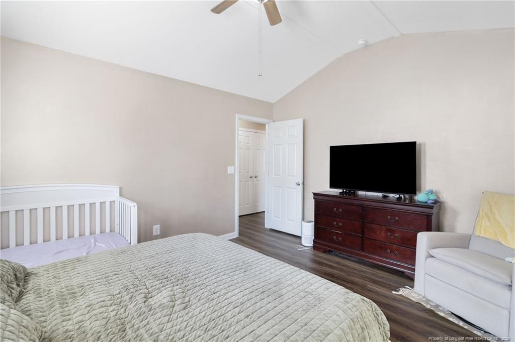 46 Old English Lane Spring Lake, NC 28390 - Photo 22 of 36 a bedroom with a bed and a flat screen tv
