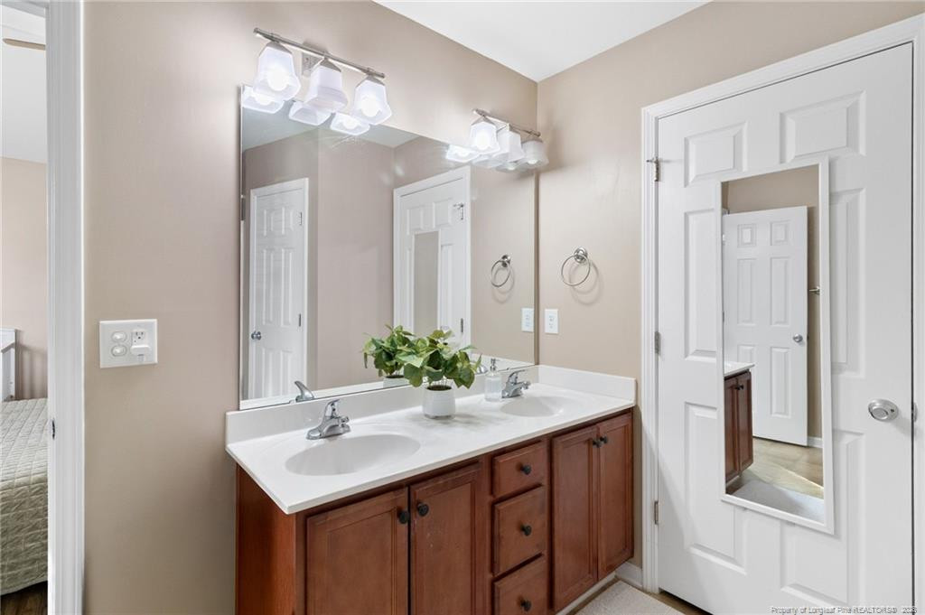 46 Old English Lane Spring Lake, NC 28390 - Photo 24 of 36 a bathroom with a sink and a mirror