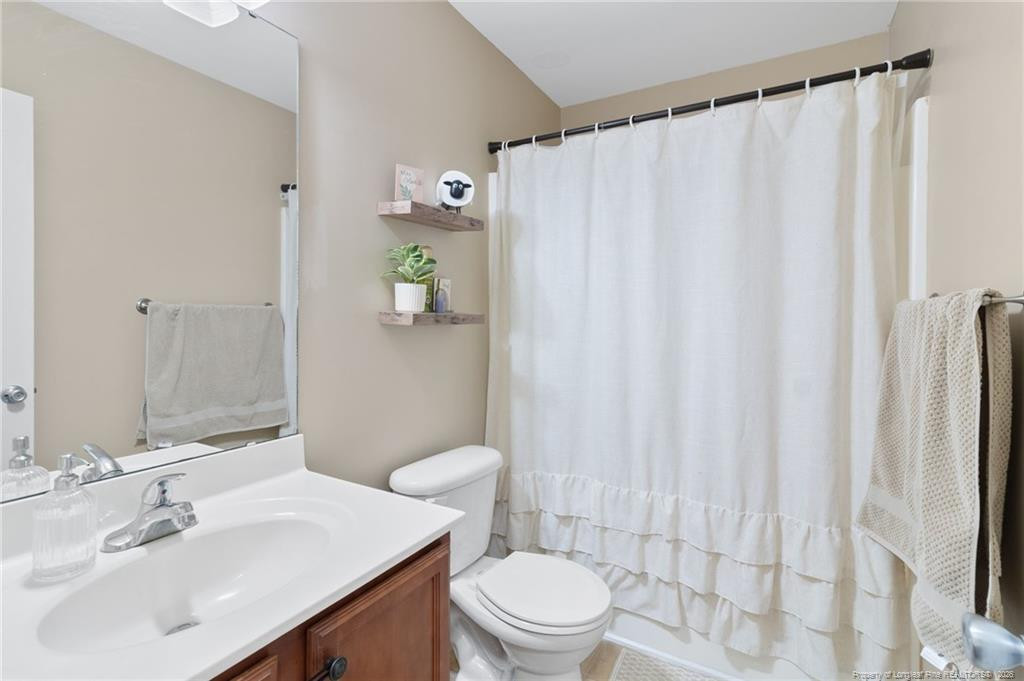 46 Old English Lane Spring Lake, NC 28390 - Photo 27 of 36 a bathroom with a sink a toilet and shower curtain