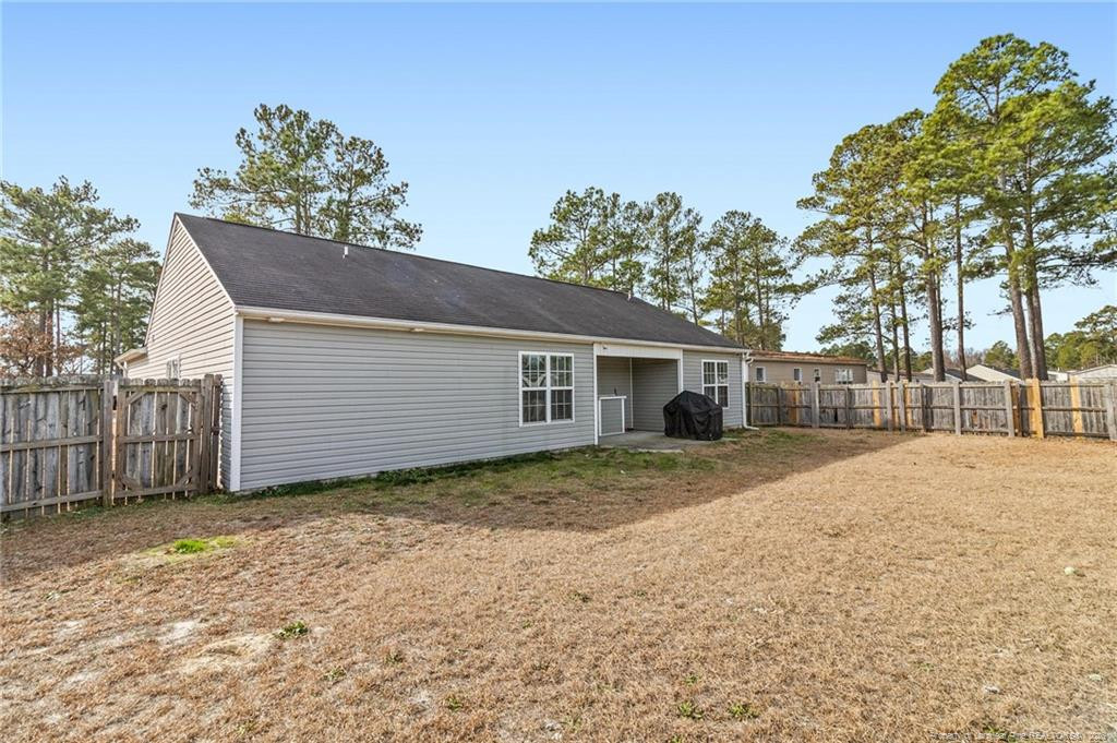46 Old English Lane Spring Lake, NC 28390 - Photo 31 of 36 a view of a yard in front of a house with a large tree