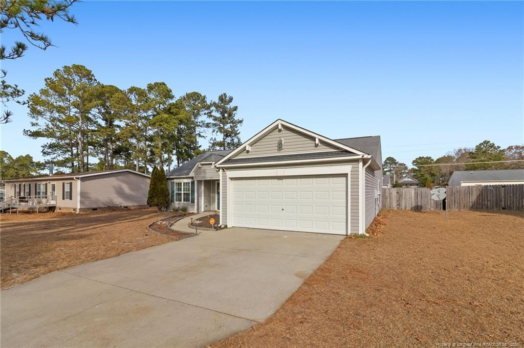 46 Old English Lane Spring Lake, NC 28390 - Photo 4 of 36 a front view of a house with a yard and garage