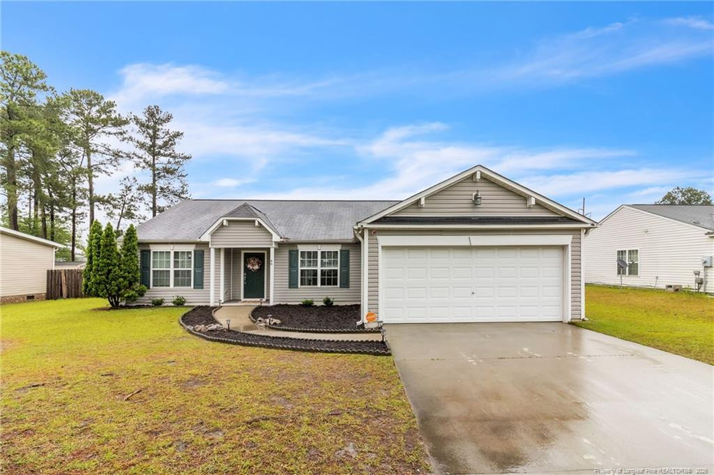 46 Old English Lane Spring Lake, NC 28390 - Photo 6 of 36 a front view of house with yard and trees in the background