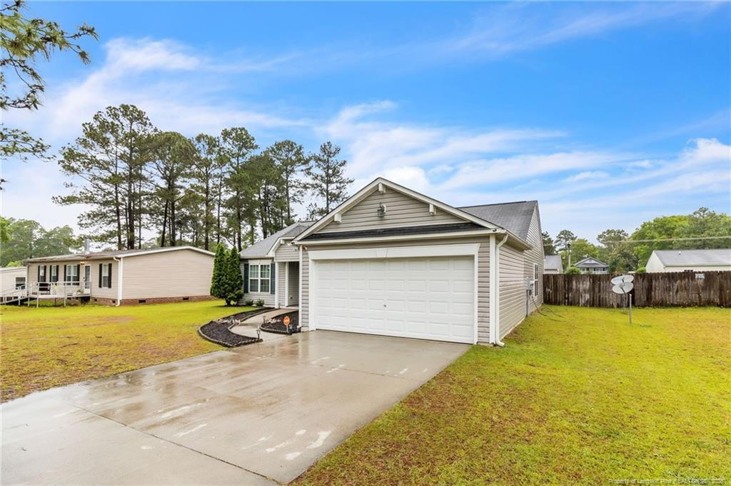 46 Old English Lane Spring Lake, NC 28390 - Photo 8 of 36 a front view of a house with a yard and lake view