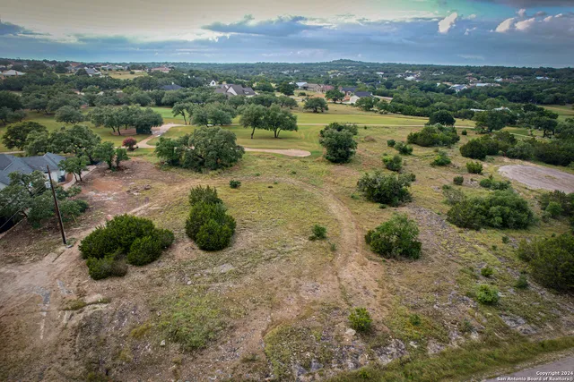 an aerial view of a houses with a yard