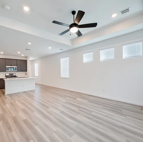 an empty room with a empty space and windows