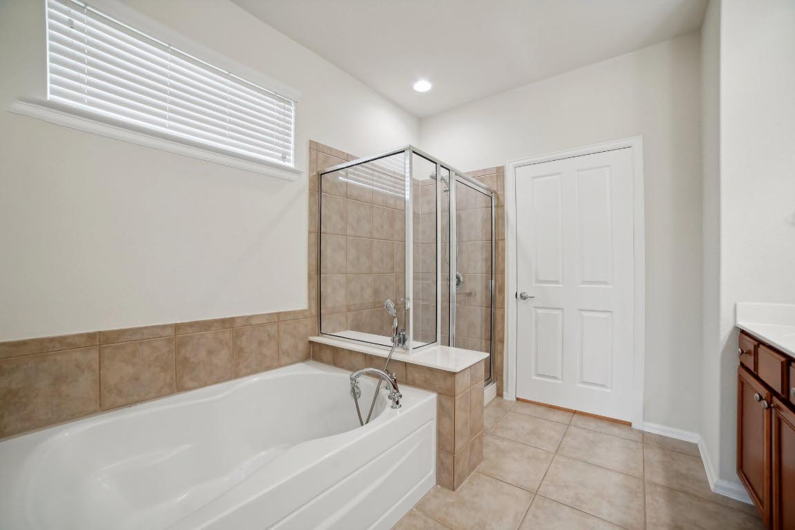 207 Trinity Lane Georgetown, TX 78633 - Photo 20 of 37 a bathroom with a bathtub and shower