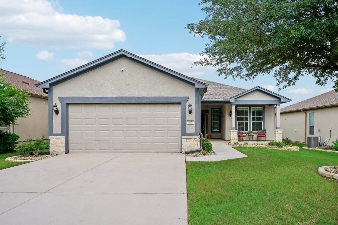 207 Trinity Lane Georgetown, TX 78633 - Photo 2 of 37 a front view of a house with a yard and garage