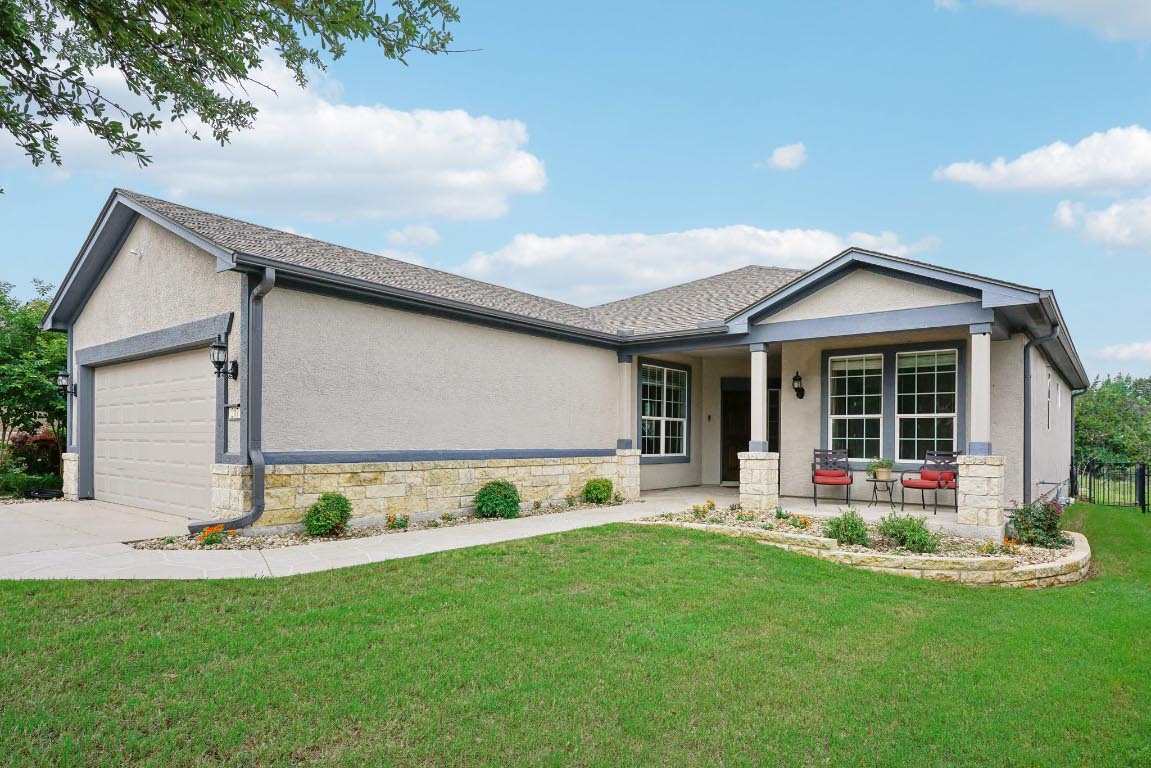 207 Trinity Lane Georgetown, TX 78633 - Photo 4 of 37 a front view of a house with a yard and porch