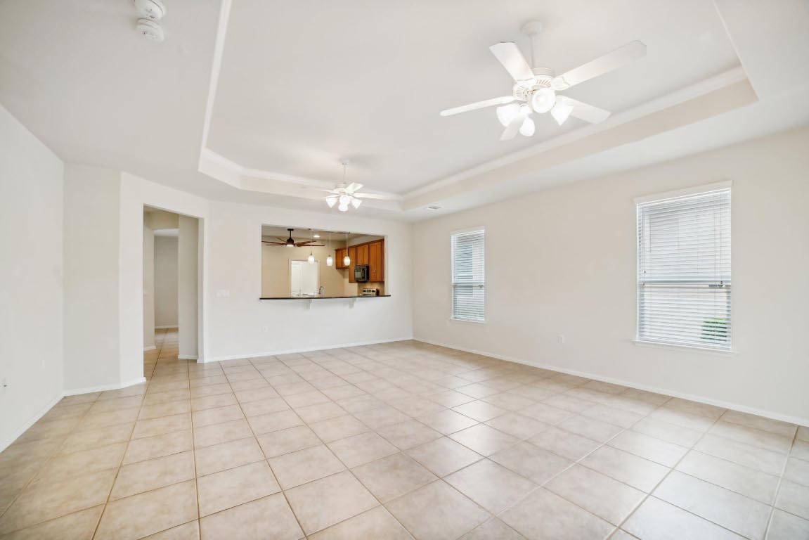 207 Trinity Lane Georgetown, TX 78633 - Photo 8 of 37 wooden floor in an empty room with a window