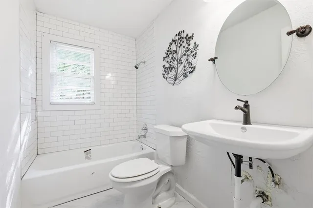 a bathroom with a sink toilet and bathtub