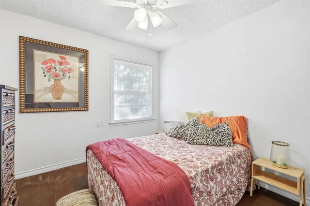 a bedroom with a bed and a painting on the wall