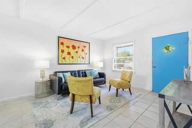 a view of a livingroom with furniture and a window