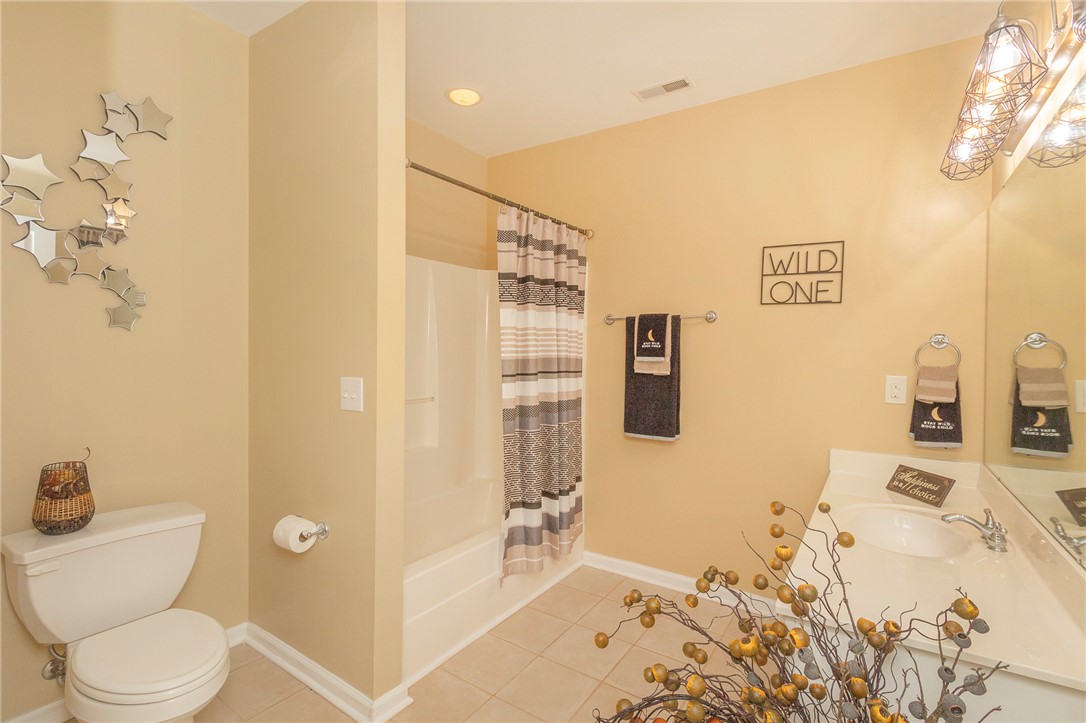 125 Inlet Pointe Drive Anderson, SC 29625 - Photo 33 of 39 A well-lit lavatory features a combined shower and tub, with practical amenities for daily routines.
