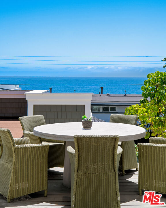 25157 Malibu Road Malibu, CA 90265 - Photo 23 of 33 a view of a patio with table and chairs with wooden floor