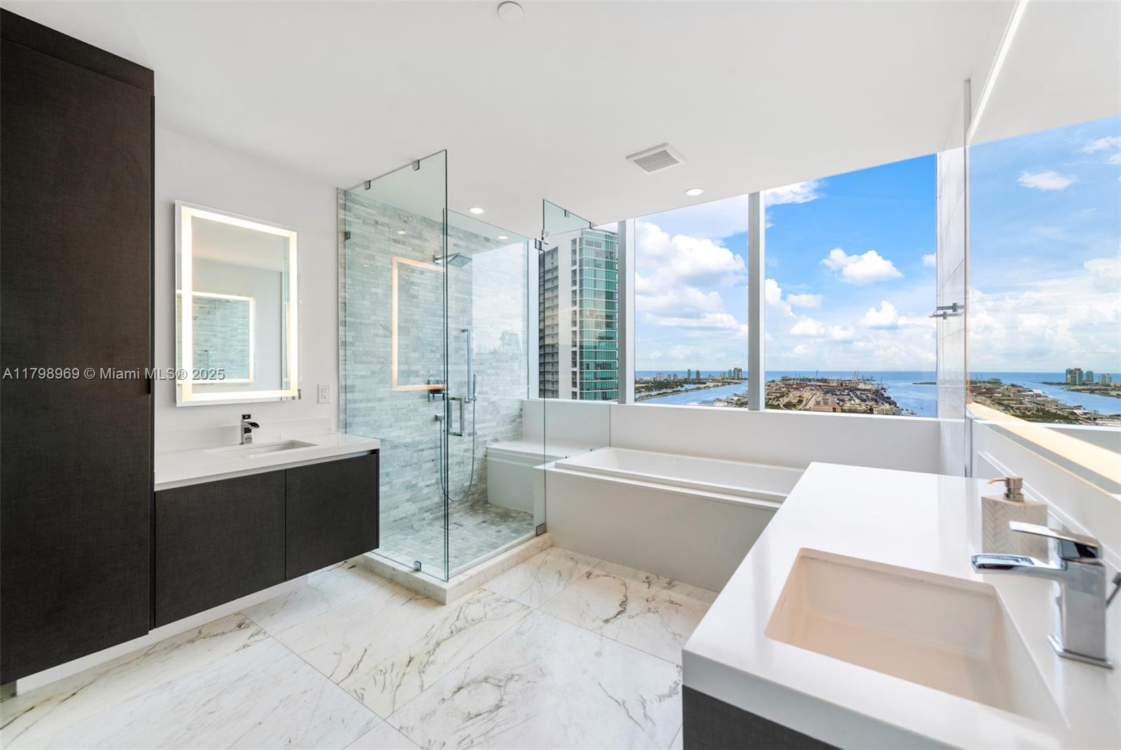 851 Northeast 1st Avenue, Unit 4011 Miami, FL 33132 - Photo 13 of 37 a large white kitchen with a large window and sink