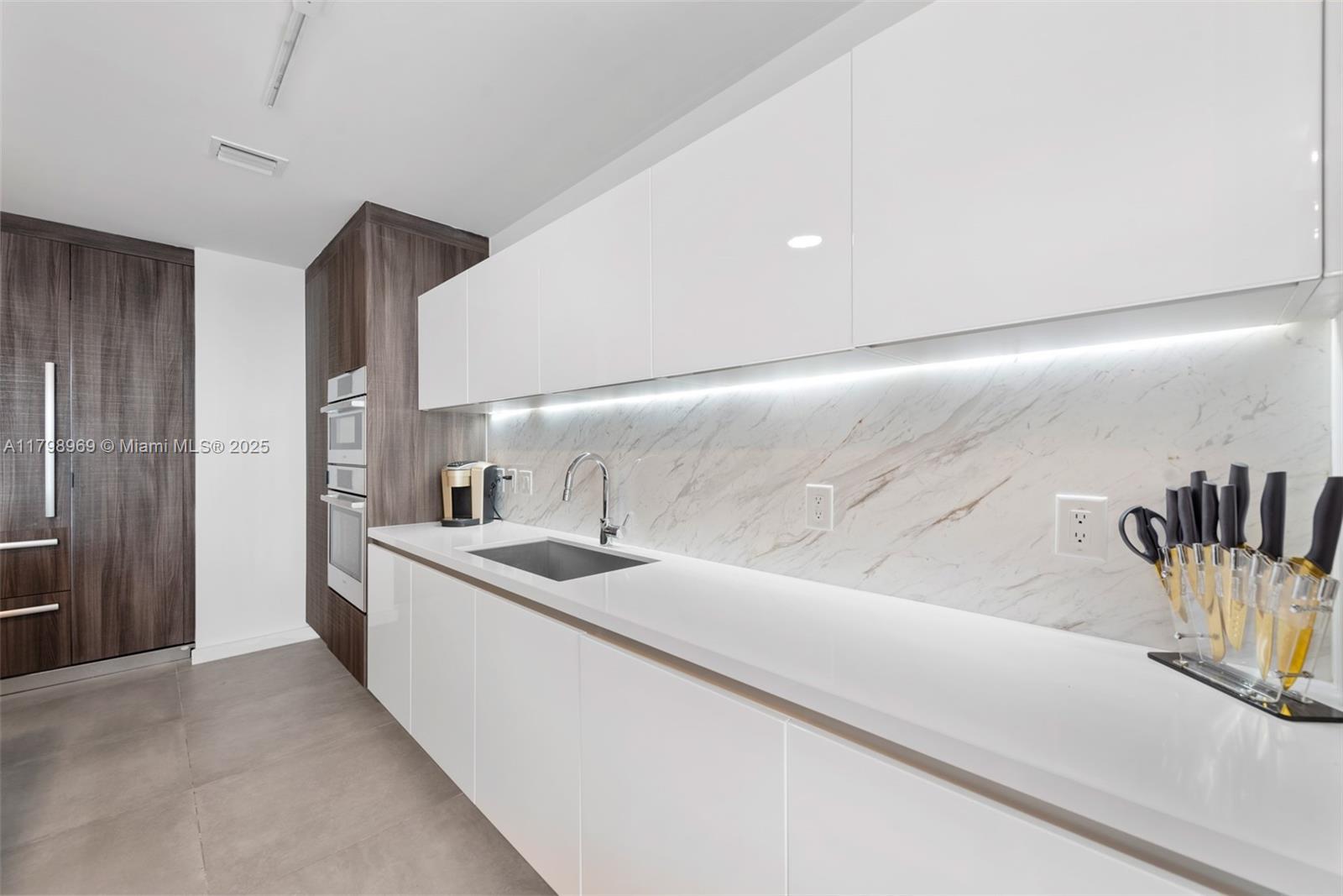 851 Northeast 1st Avenue, Unit 4011 Miami, FL 33132 - Photo 18 of 37 a kitchen with stainless steel appliances granite countertop a sink and a refrigerator