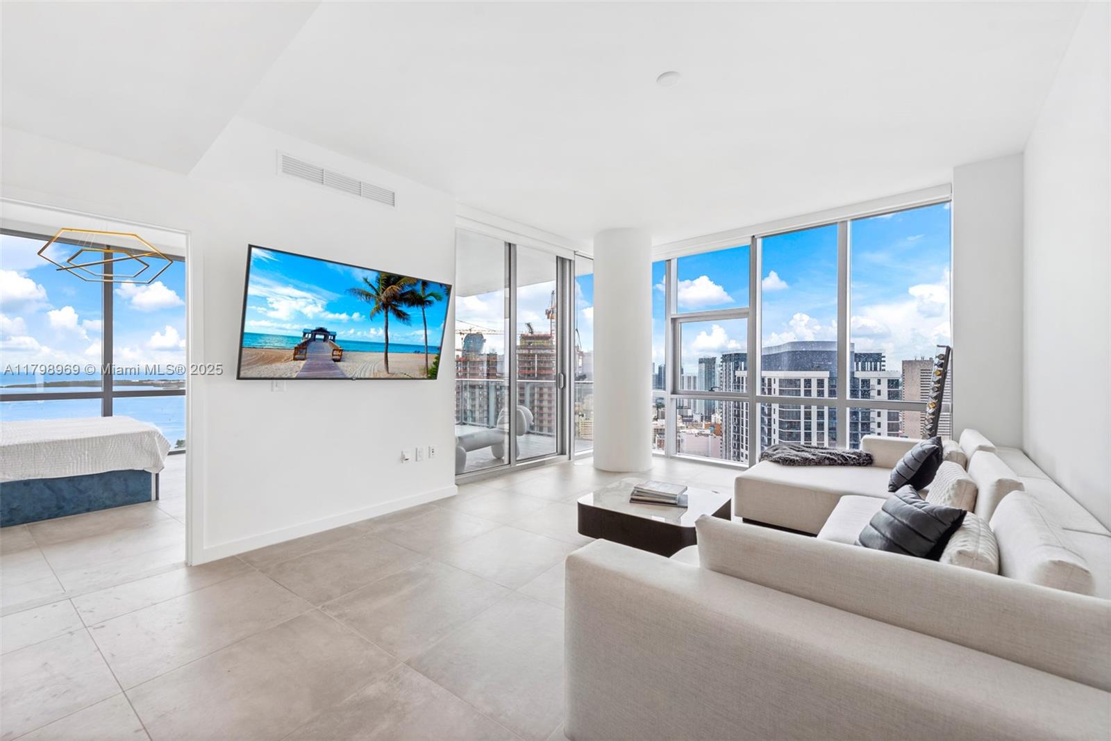 851 Northeast 1st Avenue, Unit 4011 Miami, FL 33132 - Photo 2 of 37 a living room with furniture and a flat screen tv