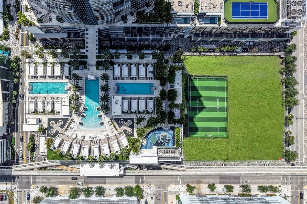 851 Northeast 1st Avenue, Unit 4011 Miami, FL 33132 - Photo 35 of 37 a front view of a building with glass windows and plants