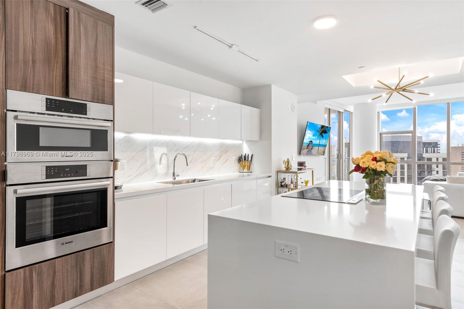 851 Northeast 1st Avenue, Unit 4011 Miami, FL 33132 - Photo 4 of 37 a kitchen with a sink cabinets and stainless steel appliances