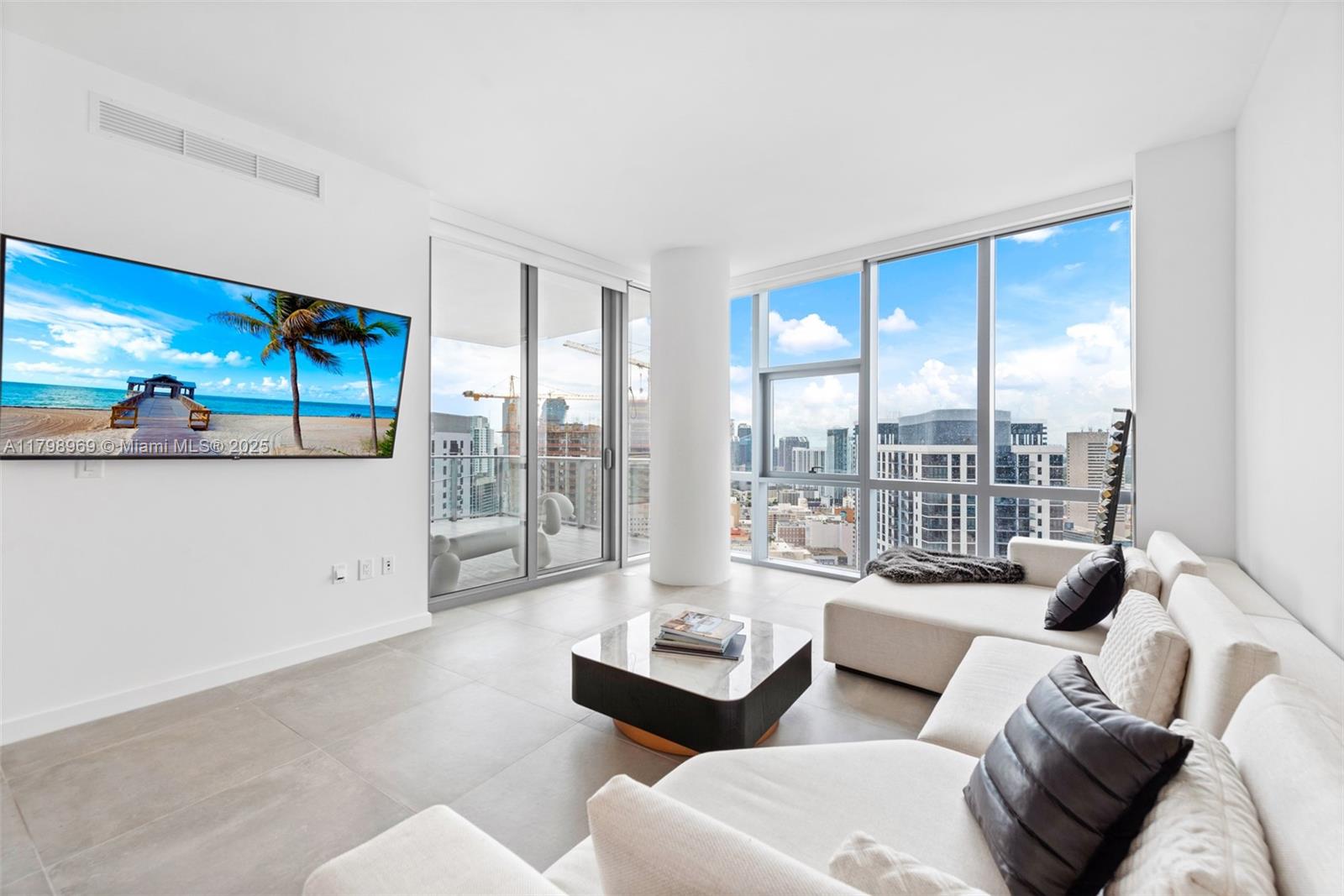 851 Northeast 1st Avenue, Unit 4011 Miami, FL 33132 - Photo 7 of 37 a living room with furniture and a large window