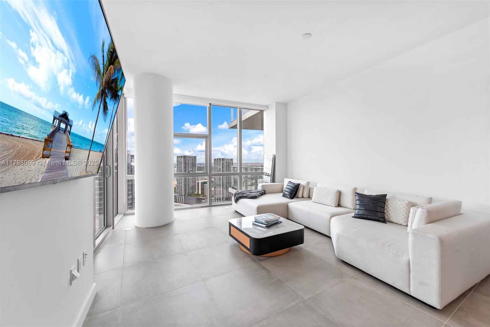 851 Northeast 1st Avenue, Unit 4011 Miami, FL 33132 - Photo 8 of 37 a living room with furniture and a floor to ceiling window
