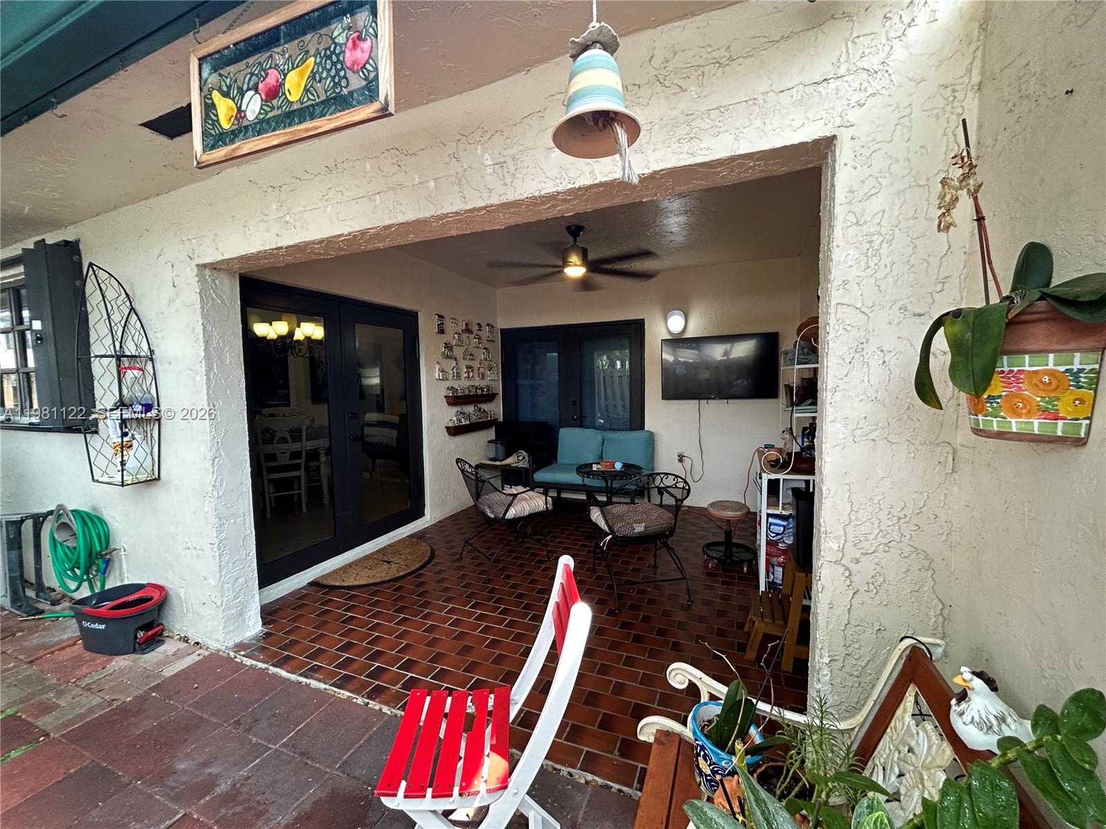 10818 Southwest 72nd Street, Unit 154 Miami, FL 33173 - Photo 11 of 28 a living room with furniture a rug and white walls