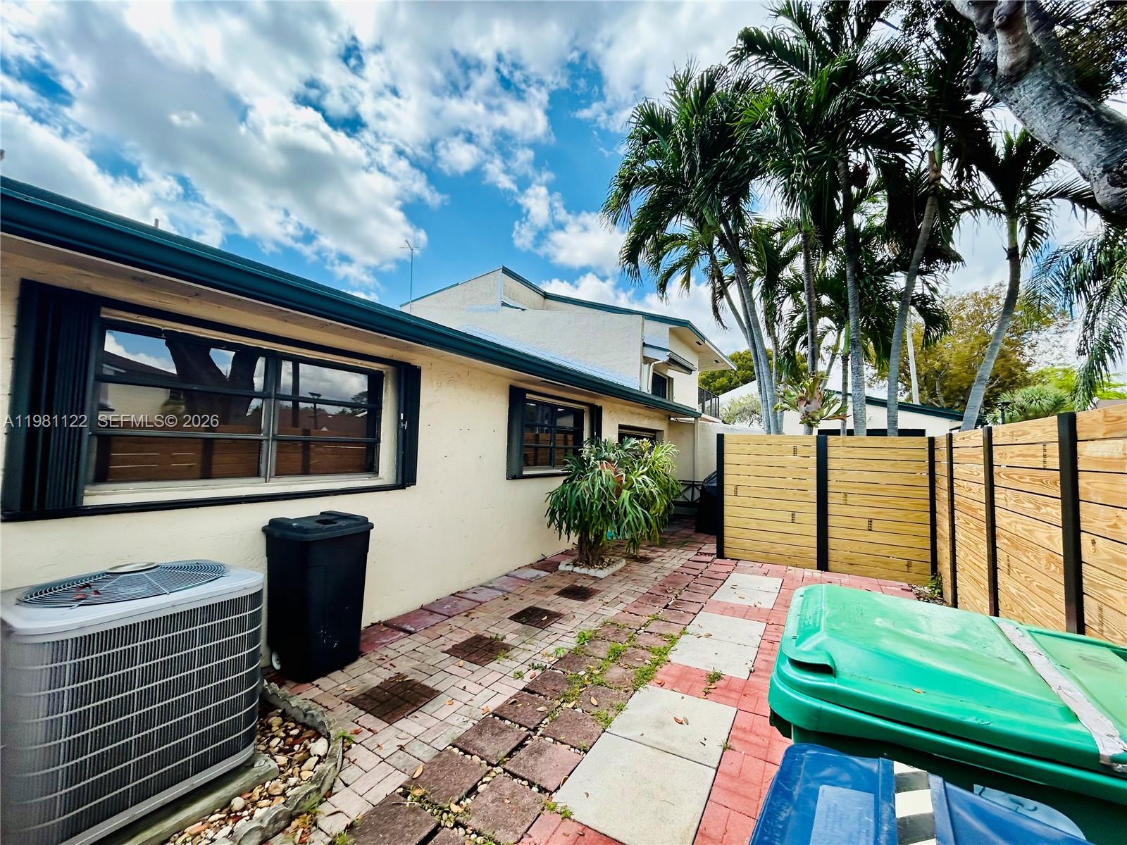 10818 Southwest 72nd Street, Unit 154 Miami, FL 33173 - Photo 14 of 28 a front view of a house with a yard