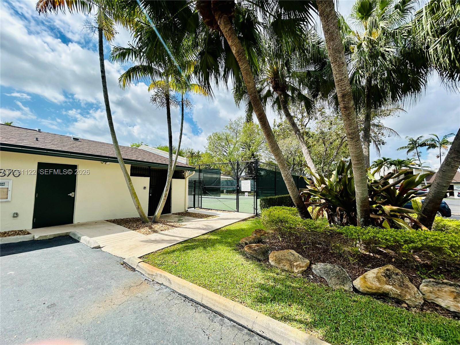 10818 Southwest 72nd Street, Unit 154 Miami, FL 33173 - Photo 19 of 28 a view of a backyard with plants and palm trees