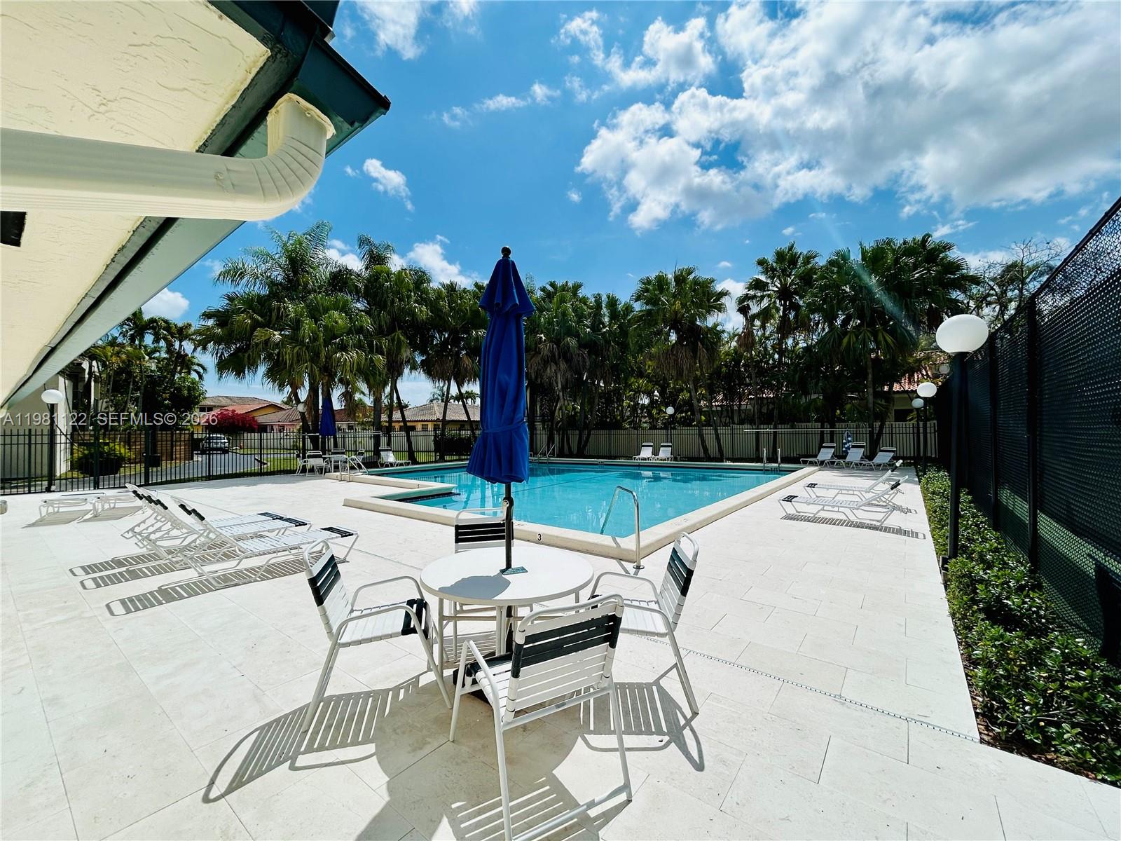 10818 Southwest 72nd Street, Unit 154 Miami, FL 33173 - Photo 21 of 28 a view of a backyard with sitting area