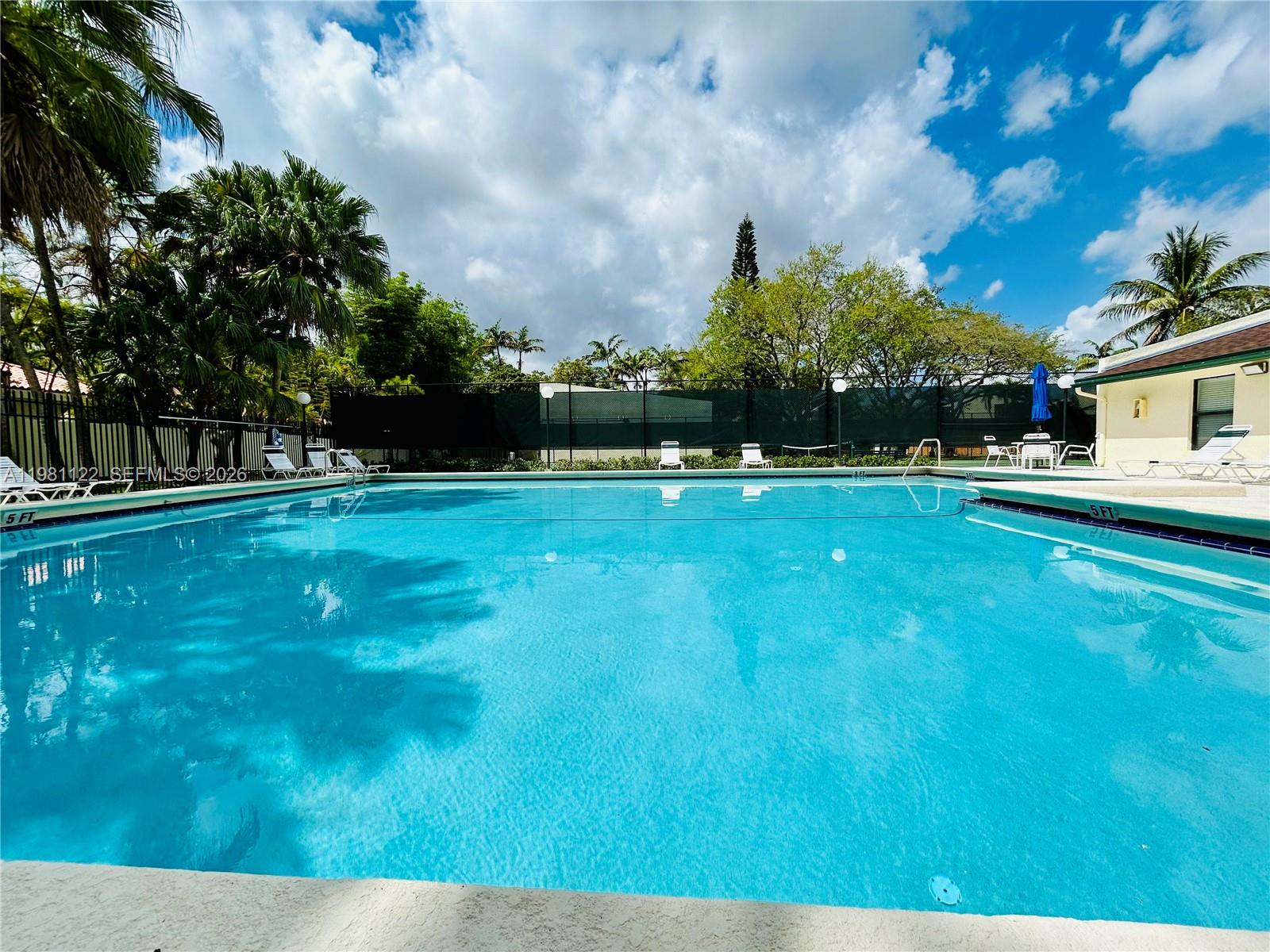 10818 Southwest 72nd Street, Unit 154 Miami, FL 33173 - Photo 23 of 28 a view of swimming pool is middle in the garden