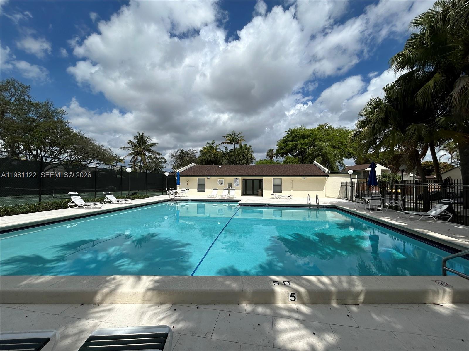 10818 Southwest 72nd Street, Unit 154 Miami, FL 33173 - Photo 25 of 28 a front view of a house with a garden