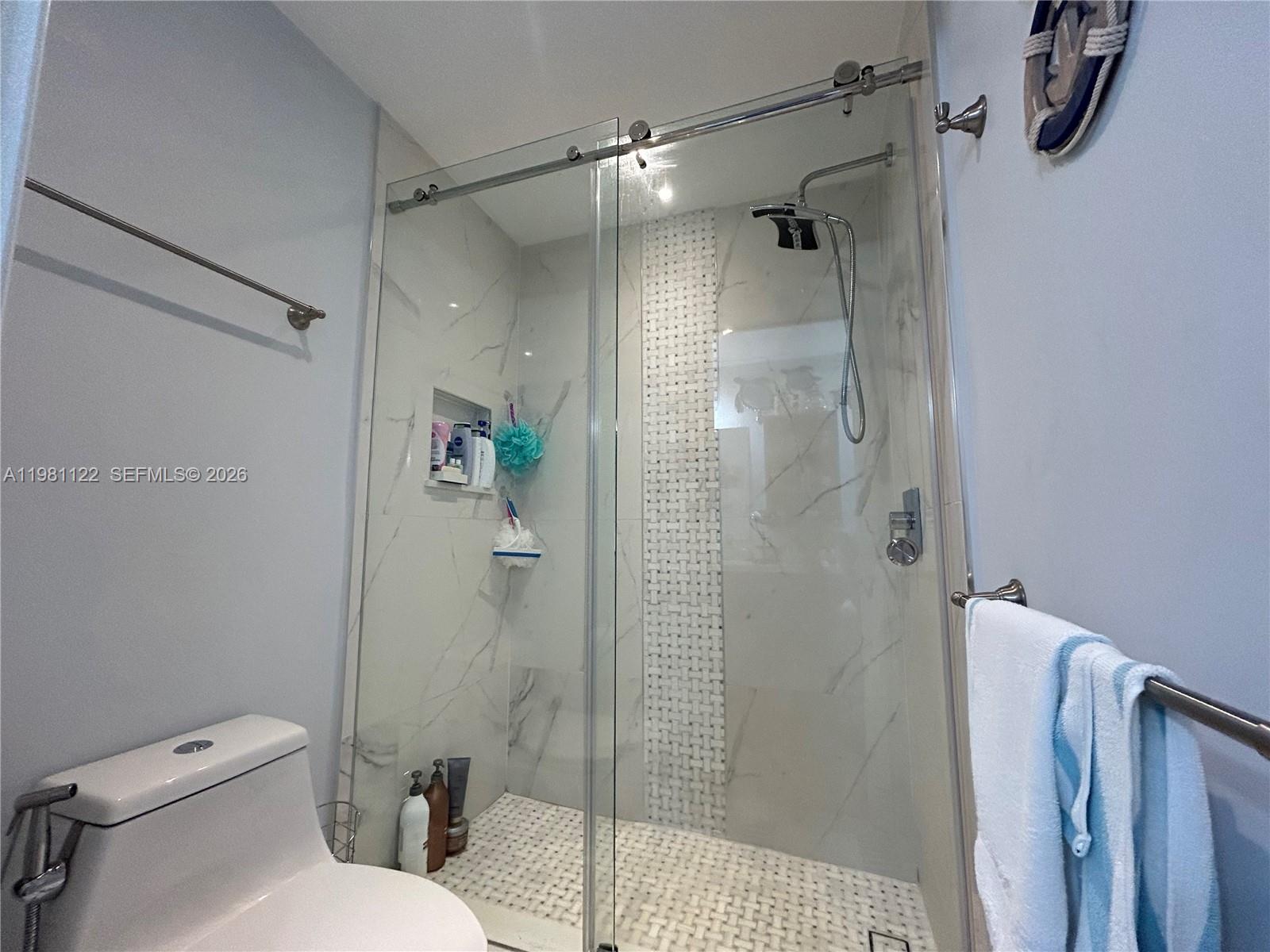 10818 Southwest 72nd Street, Unit 154 Miami, FL 33173 - Photo 6 of 28 a bathroom with a shower and a toilet